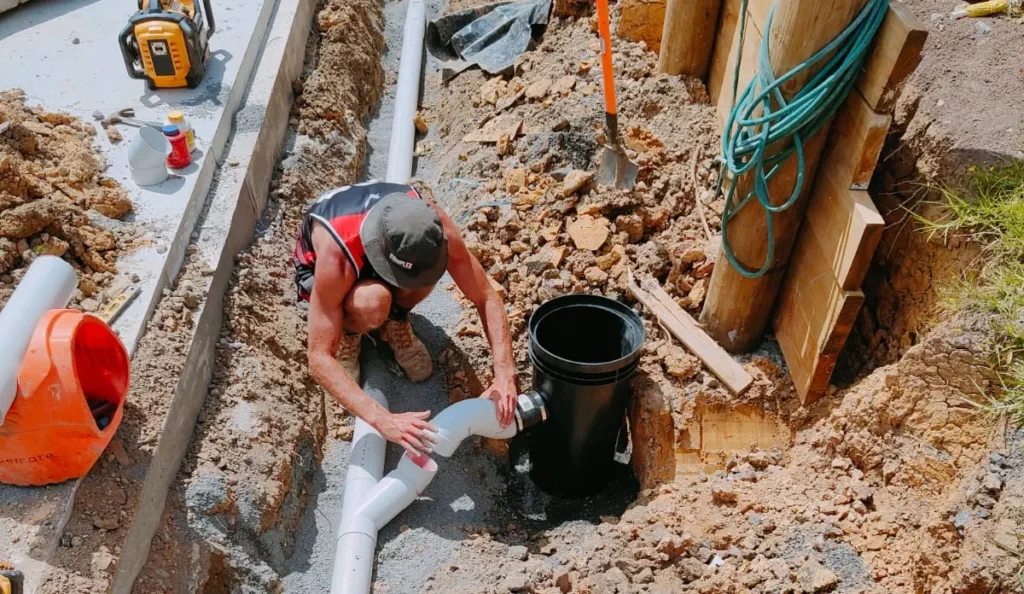 professional drainage worker installing new residential drainage system